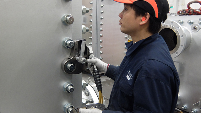 asian man inspecting compabloc welded plate heat exchanger
