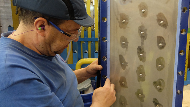 Man checking panel gaskets on Alfa Laval Compabloc welded plate heat exchanger